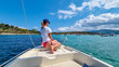 © Chris - Woman sitting on bow of luxury boat in the blue lagoon of Vourvourou on peninsula Sithonia, Chalkidiki (Halkidiki), Greece, Europe. Tropical crystals clear turquoise water. Summer vacation atmosphere