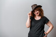 © Artframe  - Happy woman with red curly hair posing on grey background
