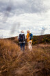 © Zoran Zeremski - Rear view of active senior couple with backpacks hiking together in nature on autumn day.