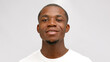 © orientka - African-American young bearded man smiles with satisfaction on white studio background