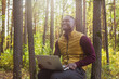 © satura_ - African american man sitting in city park on a bench with laptop studying online outdoors. Man freelancer learn working remotely in street e-learning