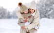 © JenkoAtaman - Happy mother embracing little girl daughter while having fun in snowy weather outdoor
