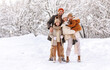 © JenkoAtaman - Happy family in warm clothes smiling at camera while playing on fresh air in winter snowy forest