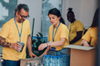 © Zamrznuti tonovi - Group of multiracial volunteers working in community charity donation center
