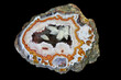 A cross section of the agate stone with geode. Quartz geode in eyelet-type agate with beautifully shaped calcite and goethite crystals. Origin: Morocco, High Atlas area around Aquim.