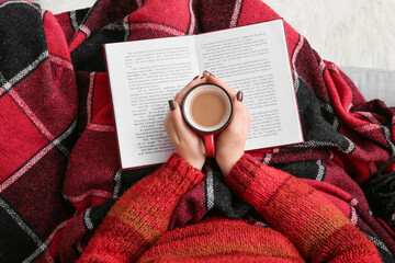 Poster - Woman with cup of coffee reading book, closeup