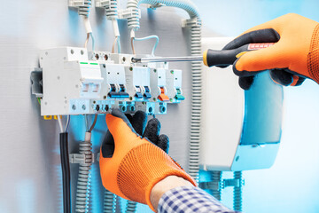 Wall Mural - Electrician working at electric panel. Technician is repairing the switchboard.