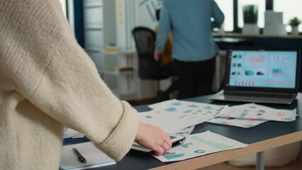 Wall Mural - Selective focus on woman hands holding tablet zooming in on sales pie chart and comparing data with statistics on laptop screen. Closeup of startup employee working digital device in office.