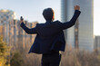 © Blue Jean Images - Cheerful businessman punching the air