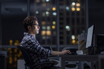 IT worker working in office at night