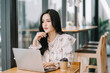 © Kritdanai - Portrait of smiling beautiful business asian woman working in modern office desk using tablet laptop computer, Business people employee freelance online marketing e-commerce telemarketing concept.