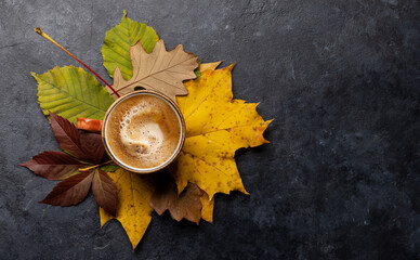 Coffee cup and autumn leaves