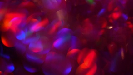 Wall Mural - Purple red bokeh motion. Festive purple, blue and red luminous colorful lights bokeh movement background. Purple bokeh lights abstract moving background.