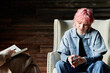 © TrueFrame Collective - Teenage girl with pink hair sitting on chair at psychotherapy and talking to psychotherapist