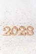 Leinwandbild Motiv Holiday background Happy New Year 2023. Numbers of year 2023 made by gold candles on bokeh festive sparkling background. celebrating New Year holiday, close-up. Space for text