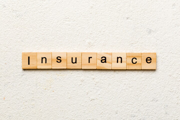 Wall Mural - insurance word written on wood block. insurance text on table, concept