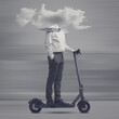 Businessman with head in a cloud riding an electric scooter