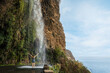 © ronstik - Cascata dos Anjos - woman standing under Angels waterfall in Madeira