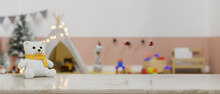 White Marble Tabletop With Cute Plush Toy And Copy Space Over Blurred Baby Kid Playroom