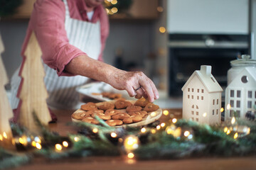 Wall Mural - Close-up of senior man baking Christmas gingerbreads.