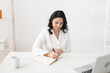 © satura_ - Indian woman beautician takes notes in office - cosmetologist business woman or doctor concept