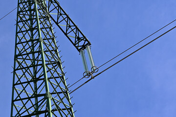 Wall Mural - The top of the transmission tower for electrical transmission line. Close-up with glass disk insulators and electric cables. 