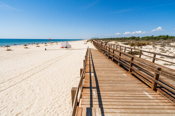 Sticker - Wide sandy beach with wooden bridges along dunes in Monte Gordo, Algarve, Portugal