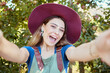 © J Maas/peopleimages.com - Happy, woman and travel for nature selfie excited on summer vacation enjoying the countryside in the outdoors. Portrait of female traveler in joyful happiness with smile for photo adventure or trip