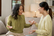 © NanSan - Asian mature mom and adult daughter have fight at home while sitting on sofa.