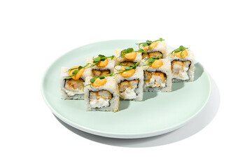 Wall Mural - Maki sushi with sesame outside, tempura shrimp inside topped spicy sauce and microgreens. Spicy shrimp maki roll on ceramic plate isolated on white background Sushi roll with crispy prawn on plate