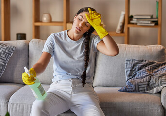 Canvas Print - Spring cleaning, tired and sad woman headache in home living room with burnout, stress and frustrated spray task. Fatigue, pain and depression, housekeeping cleaner and exhausted maid service problem