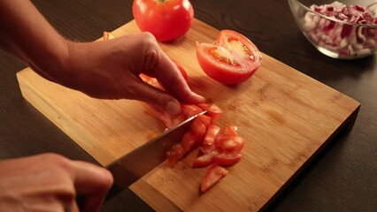 Canvas Print - woman hands cutting tomatoes at home on wooden board