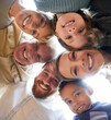 © Allistair F/peopleimages.com - Family, face and below huddle for support of grandparents, parents and children together with smile, happiness and love circle. Men, women and diversity kids hugging, smiling and happy about adoption