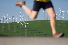 A Man Running Near Windmills On Patterson Pass Near Livermore California.