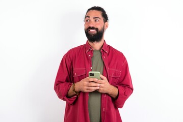 caucasian man with beard wearing red shirt over white background hold telephone hands read good yout