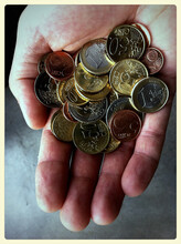 A Male Hand Holding Spare Change In Euro Coins.