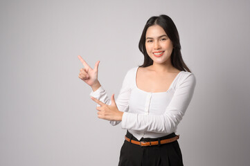 Wall Mural - Portrait of young beautiful woman smiling over white background studio