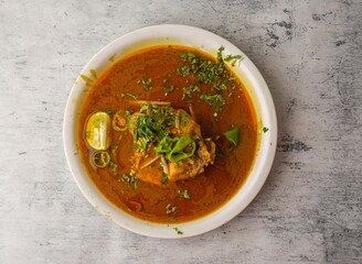 Spicy chicken nihari served in a plate isolated on background top view of indian and pakistani desi food