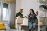 Fototapeta  - female college student move in dorm. they are talking in the room