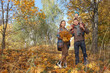© Irina - happy family walking in autumn park.