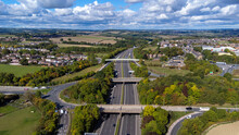 Aerial Drone Photo Of The Busy M1 Motorway With Three Bridges Crossing Over The Highway In The Village Of Barnsley In Sheffield UK In The Summer Time On A Bright Sunny Summers Day.