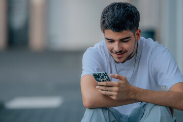 Poster - young man on the street looking at the phone or smartphone