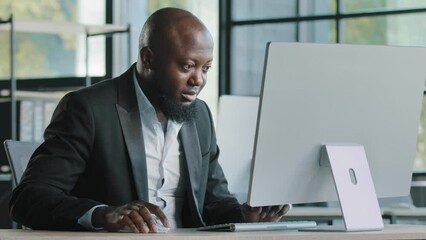 Professional man worker african american 40s businessman millennial ethnic male salesman develop online project work on personal computer in modern office company coding business program ecommerce job