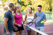 © JackF - Four tennis players standing on court and talking friendly about match