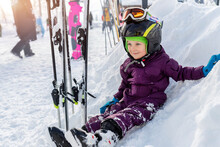 Cute Adorable Little Kid Boy Enjoy Having Fun Sledging Down Hill Of Snow Heap Snowdrift At Alpine Mountain Skiing Resort On Bright Winter Day. Toddler Beginner Skier Rest Of Training In Ski School