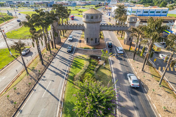 Paulinia, Sao Paulo, Brazil. October 25 2022: Portal of the city of Paulínia in the interior of São Paulo. Cars, city entrance and castle style portal.