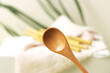 Eco bamboo spoon on green background. Concept, natural material organic cutlery, zero waste, eco-friendly