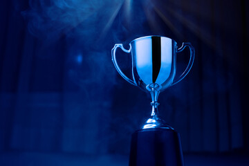 Wall Mural - silver trophy competition in the dark with smoke and with copy space