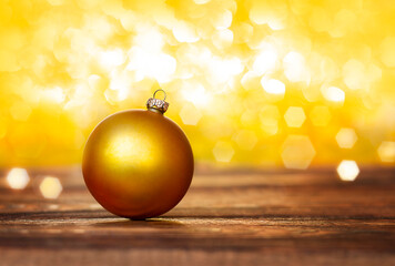 Wall Mural - christmas ornament on wooden floor on yellow background with bokeh