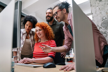 Smiling diverse colleagues gather in boardroom brainstorm discuss financial statistics together